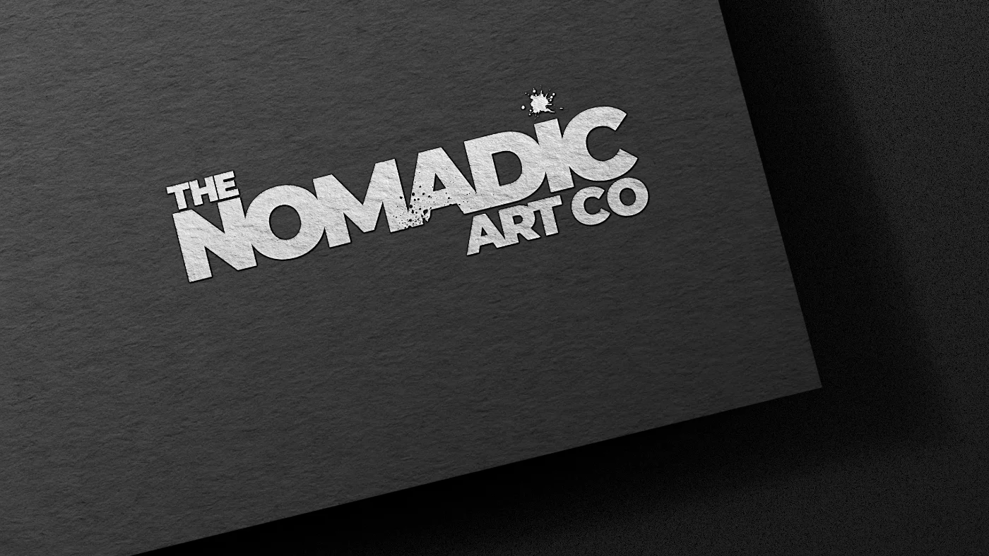 The Nomadic Art Co, presented in silver on a black textured background